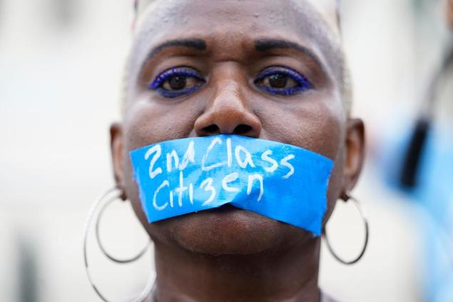 An abortion-rights activist wears tape reading \\\"2nd Class Citizen\\\" on their mouth as they protest outside the Supreme Court in Washington, Friday, June 24, 2022.\\u00C2\\u00A0The\\u00C2\\u00A0Supreme Court\\u00C2\\u00A0has ended constitutional protections for abortion that had been in place nearly 50 years in a decision by its conservative majority to overturn\\u00C2\\u00A0Roe v. Wade.\\u00C2\\u00A0(AP Photo/Jacquelyn Martin)