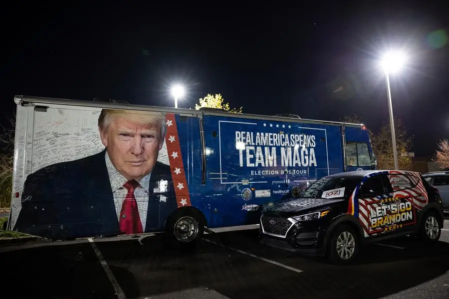 Vehicles adorned with messaging in support of former President Donald Trump and in opposition to President Joe Biden are seen outside Pennsylvania Republican senatorial candidate Mehmet Oz's election-night party in Newtown, Pa., on Election Day, Nov. 8, 2022. (Francis Chung/E&E News/POLITICO via AP Images)