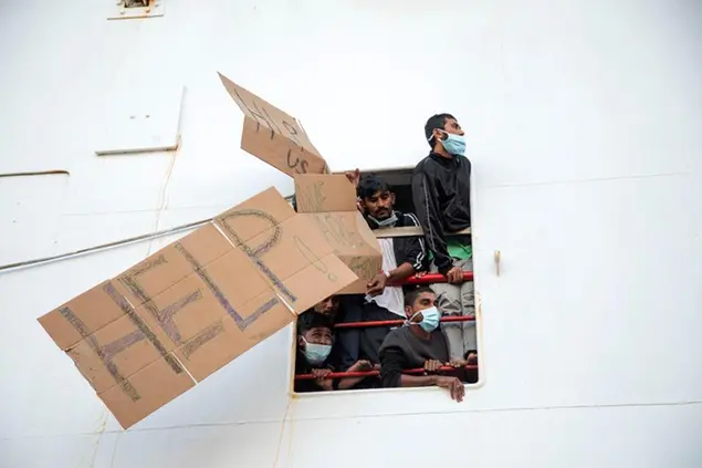 Migrants show placards demanding the disembark for all as the wait aboard of the Norway-flagged Geo Barents rescue ship , in Catania's port, Sicily, southern Italy, Tuesday, Nov. 8, 2022. The Geo Barents, and the German-flagged Humanity1 have been allowed to disembark what the Italian authorities defined \\\"vulnerable people\\\" and minors, while other two ships carrying rescued migrants remained at sea. (AP Photo/Massimo Di Nonno) Associated Press/LaPresse Only Italy