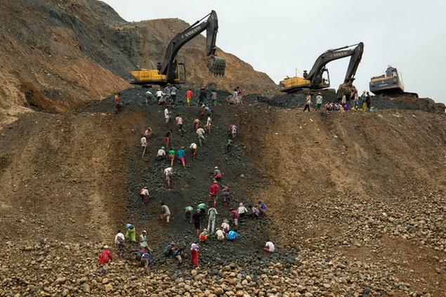 FILE - In this June 15, 2015, file photo, freelance jade miners collect jade stones in an earth dump of a companies' mining field in Hpakant area, Kachin State, Northern Myanmar. A report by the independent research group Global Witness says Myanmar\\u2019s Feb. 1 military takeover has crushed prospects for better safety and environmental controls in its lucrative but conflict-ridden jade mining sector.(AP Photo/Hkun Lat, File)