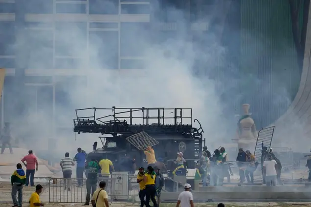 Protesters, supporters of Brazil's former President Jair Bolsonaro, attack a police armored vehicle after they stormed the Planalto Palace in Brasilia, Brazil, Sunday, Jan. 8, 2023. Planalto is the official workplace of the president of Brazil. (AP Photo/Eraldo Peres)