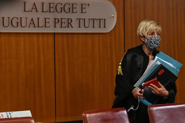 Judge Marina Finiti enters the court room to attend the trial for the murder of the Italian Carabinieri paramilitary police officer Mario Cerciello Rega, in Rome, Monday, July 20, 2020. Two tourists from California are accused of murdering Cerciello during their summer vacation in Italy in July 2019. (Andreas Solaro/Pool via AP)