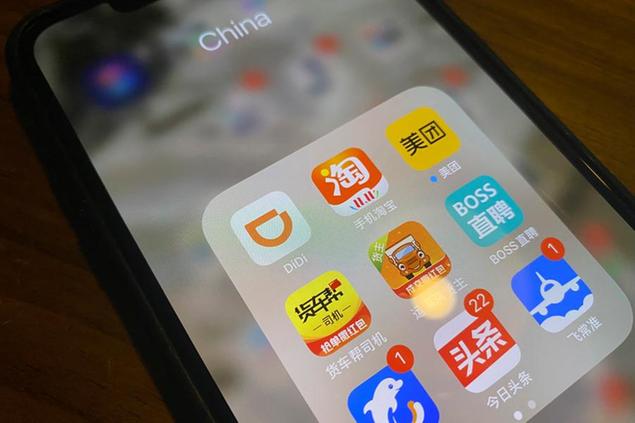 The ride-hailing app Didi is seen near other Chinese apps on a phone in Beijing on Monday, July 5, 2021. Chinese regulators have clamped down on the country\\u00E2\\u20AC\\u2122s largest ride-hailing app, Didi Global Inc., days after its shares began trading in New York. Authorities told Didi to stop new registrations and ordered its app removed from China\\u00E2\\u20AC\\u2122s app stores pending a cybersecurity review. (AP Photo/Ng Han Guan)