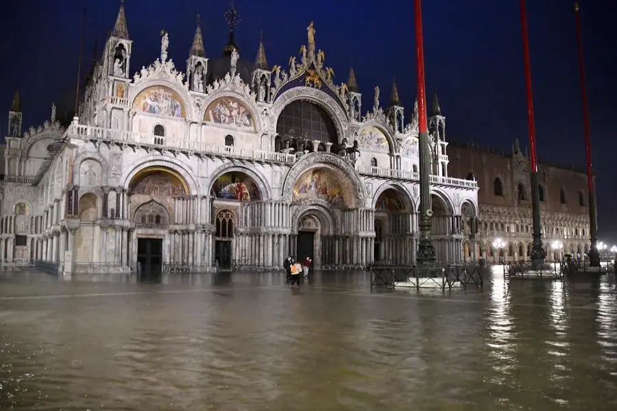A view of flooded St. Mark square in Venice, Italy, Thursday night, June 4, 2020. Venice has been submerged by a near-record high tide that is rare for this time of year. The water level in the lagoon city reached 116 centimeters late Thursday, the third-highest mark for June. That level indicates around a quarter of Venice has been flooded. (AP Photo/Luigi Costantini)