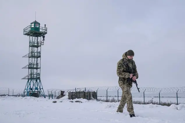 A Ukrainian border guard patrols the border with Russia not far from Hoptivka village, Kharkiv region, Ukraine, Wednesday, Feb. 2, 2022. Russian President Vladimir Putin is accusing the U.S. and its allies of ignoring Russia's top security demands but says Moscow is willing to talk more to ease tensions over Ukraine. (AP Photo/Evgeniy Maloletka)
