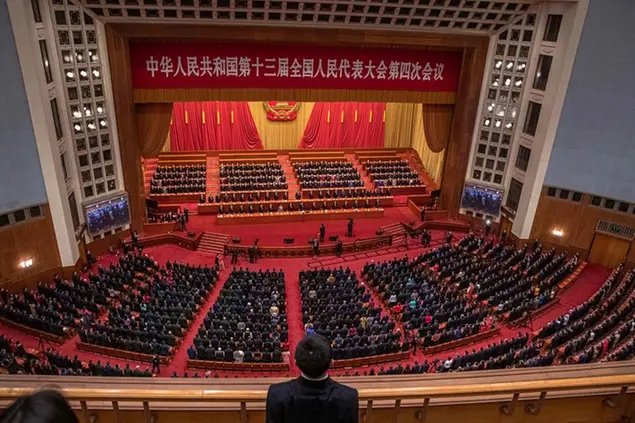 Chinese President Xi Jinping, Premier Li Keqiang and other delegates attend the closing session of the National People's Congress (NPC), at the Great Hall of the People, in Beijing, Thursday, March 11, 2021. China’s ceremonial legislature has endorsed the ruling Communist Party’s latest move to tighten control over Hong Kong by reducing the role of its public in picking the territory’s leaders. (Roman Pilipey/Pool Photo via AP)
