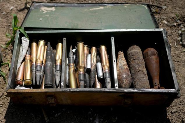 Unexploded shells and other weaponry is displayed by a Ukrainian specialized team searching for them in a field on the outskirts of Kyiv, Ukraine, Thursday, June 9, 2022. (AP Photo/Natacha Pisarenko)