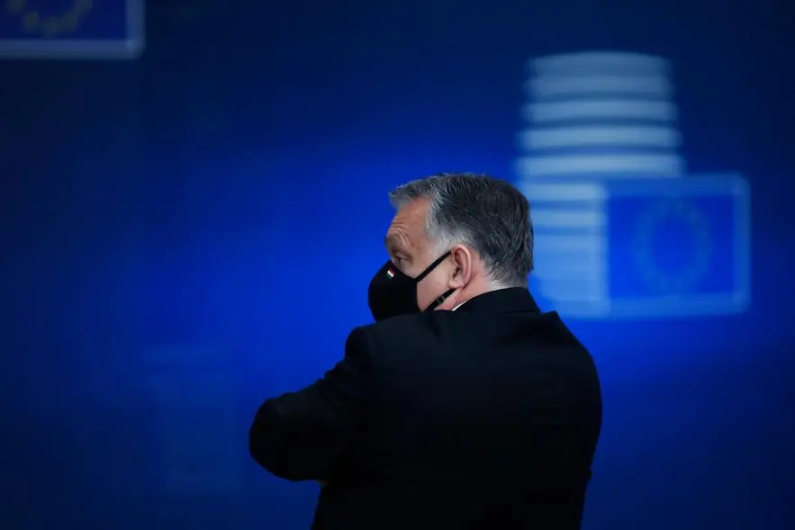 Hungary's Prime Minister Viktor Orban leaves at the end of an EU summit in Brussels, Friday, Dec. 11, 2020. European Union leaders have reached a hard-fought deal to cut the bloc's greenhouse gas emissions by at least 55 percent by the end of the decade compared with 1990 levels, avoiding a hugely embarrassing deadlock ahead of a U.N. climate meeting this weekend. (AP Photo/Francisco Seco, Pool)