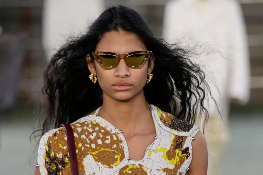 A model wears a creation as part of the Bottega Veneta Fall/Winter 2022-2023 fashion collection, unveiled during the Fashion Week in Milan, Italy, Saturday, Feb. 26, 2022. (AP Photo/Antonio Calanni)