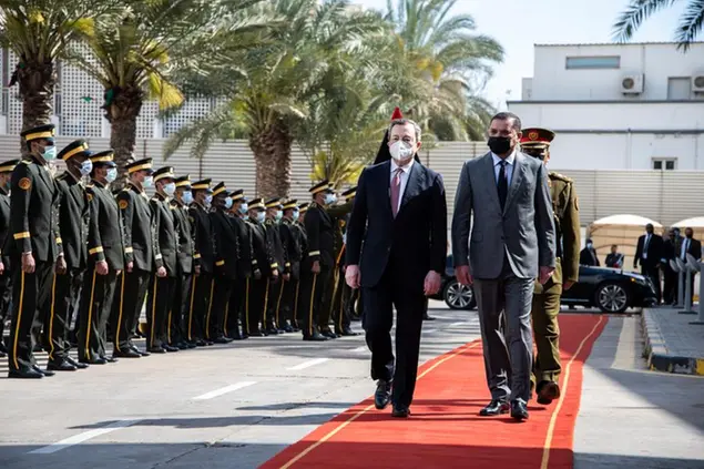 Abdul Hamid Dbeibeh, the Prime Minister of the Government of National Unity, right, welcomes Mario Draghi, the Prime Minister of Italy, Tuesday, April, 6 2021 in Tripoli, Libya. (AP Photo/Nada Harib)