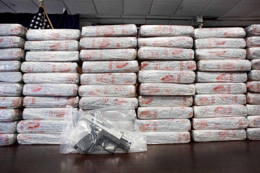 FILE - This Tuesday, May 19, 2015 file photo shows a firearm and 154 pounds of heroin worth at least $50 million displayed during a Drug Enforcement Administration news conference in New York. According to government data released Thursday, Dec. 8, 2016, drug overdose deaths in the U.S. surpassed 50,000 in 2015, the highest mark in at least 15 years. (AP Photo/Mark Lennihan)