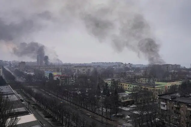 FILE - Smoke rises after shelling in Mariupol, Ukraine, March 9, 2022. An Associated Press team of journalists was in Mariupol the day of the airstrike and raced to the scene. Their images prompted a massive Russian misinformation campaign that continues to this day. (AP Photo/Evgeniy Maloletka, File)