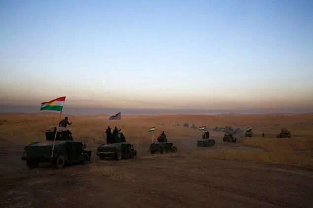 FILE -- In this Oct. 17, 2016 file photo, a Kurdish Peshmerga convoy drives towards a frontline in Khazer, about 30 kilometers (19 miles) east of Mosul, Iraq. Syriaâ€™s Kurds have been Americaâ€™s partner in fighting the Islamic State group for nearly four years. Now they are furious over an abrupt U.S. troop pull-back that exposes them to a threatened attack by their nemesis, Turkey. The surprise U.S. pull-back from positions near the Turkish border, which began Monday, Oct. 7, 2019, stung even more because the Kurds have been abandoned before by the United States and other international allies on whose support they'd pinned their aspirations. (AP Photo/Bram Janssen, File)