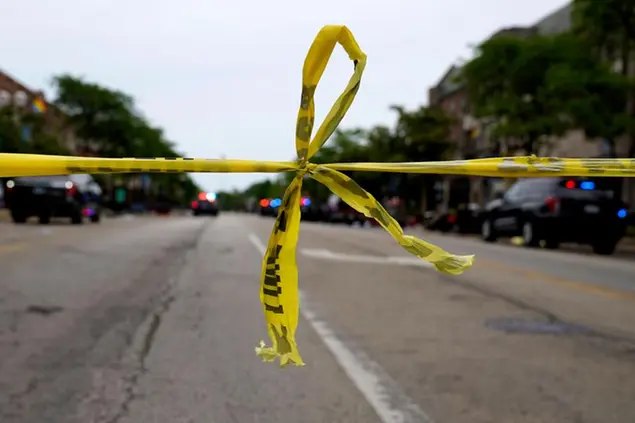 Police tape hangs at corner of Central Avenue and Green Bay Rd., in Highland Park, Ill., a Chicago suburb, Monday, July 4, 2022, after a mass shooting at Highland Park Fourth of July parade. (AP Photo/Nam Y. Huh)