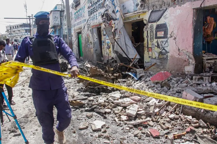 A member of security forces cordons off wreckage at the scene, after gunmen stormed a hotel in the capital Mogadishu, Somalia Sunday, Aug. 21, 2022. Somali authorities on Sunday ended a deadly attack in which at least 20 people were killed and many others wounded when gunmen from the Islamic extremist group al-Shabab, which has ties with al-Qaida, stormed the Hayat Hotel in the capital on Friday evening. (AP Photo/Farah Abdi Warsameh)
