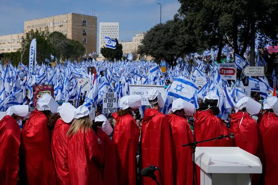 Israelis protest against plans by Prime Minister Benjamin Netanyahu's new government to overhaul the judicial system, outside the Knesset, Israel's parliament, in Jerusalem, Monday, Feb. 13, 2023. Thousands of Israelis protested outside the country's parliament on Monday ahead of a preliminary vote on a bill that would give politicians greater power over appointing judges, part of a judicial overhaul proposed by Prime Minister Benjamin Netanyahu's government. (AP Photo/Ohad Zwigenberg)