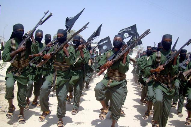 FILE - In this Thursday, Feb.17, 2011 file photo, al-Shabab fighters march with their weapons during military exercises on the outskirts of Mogadishu, Somalia. A handful of young Muslims from America are taking high-visibility propaganda and operational roles in the al-Qaida-linked insurgent force. In the meantime, the risk of another major terrorist attack in East Africa appears to be growing. (AP Photo/Mohamed Sheikh Nor, File)