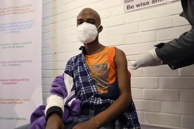 A vaccine volunteer receives an injection at the Chris Hani Baragwanath hospital in Soweto, Johannesburg Wednesday, June 24, 2020. Africa’s first participation in a COVID-19 vaccine trial has begun as volunteers received injections developed at the University of Oxford in Britain. The large-scale trial is being conducted in South Africa, Britain and Brazil. (AP Photo/Siphiwe Sibeko)