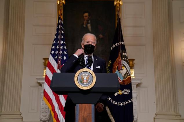 President Joe Biden arrives to speak about climate change and green jobs, in the State Dining Room of the White House, Wednesday, Jan. 27, 2021, in Washington. (AP Photo/Evan Vucci)