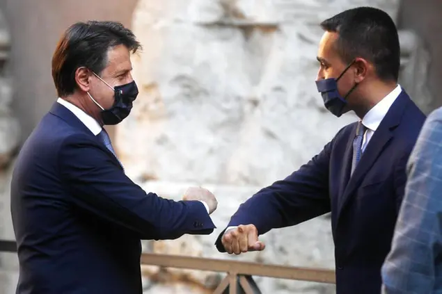 Italian Premier Giuseppe Conte, left, greets Foreign Minister Luigi Di Maio upon his arrival to the \\\"A pact for the Export \\\" meeting, in downtown Rome, Wednesday, Sept. 9, 2020. (AP Photo/Gregorio Borgia)