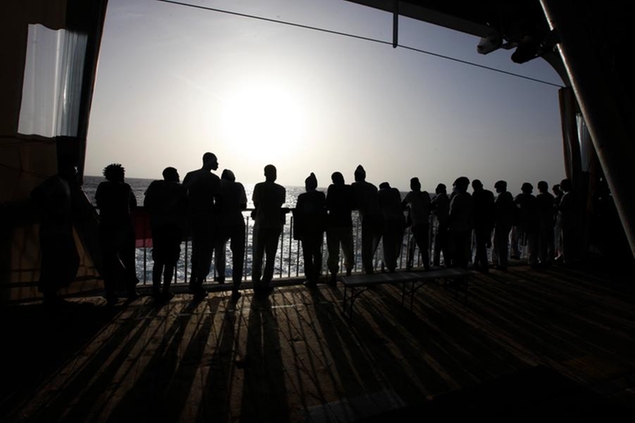 African migrants look at the Mediterranean Sea as they await disembarkation at the port of Augusta, on the island of Sicily, Italy, Monday, Sept. 27, 2021. The migrants say they were tortured and their families extorted for ransoms in Libya\\u2019s detention centers. (AP Photo/Ahmed Hatem)