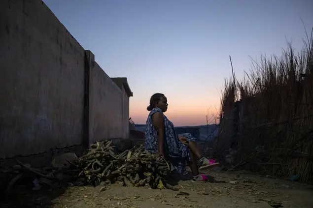 A Tigrayan refugee woman who fled the conflict in the Ethiopia's Tigray sits in front of her shelter at Hamdeyat Transition Center near the Sudan-Ethiopia border, eastern Sudan, March 14, 2021. (AP Photo/Nariman El-Mofty)