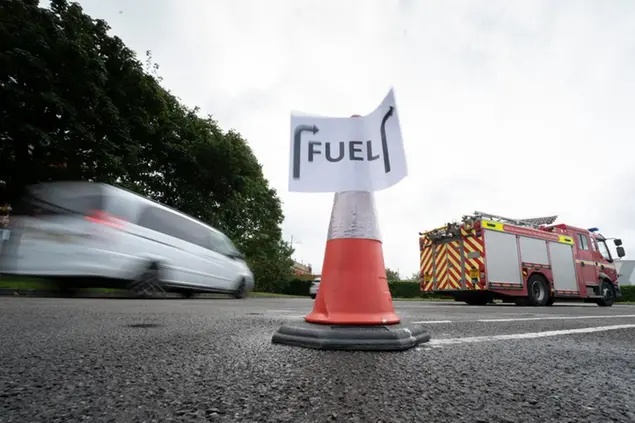 Vehicles arrive at a petrol station, in Manchester, England, Tuesday, Sept. 28, 2021. Thousands of British gas stations have run dry, as motorists scrambled to fill up amid a supply disruption due to a shortage of truck drivers. Long lines of vehicles formed at many gas stations over the weekend, and tempers frayed as some drivers waited for hours. (AP Photo/Jon Super)