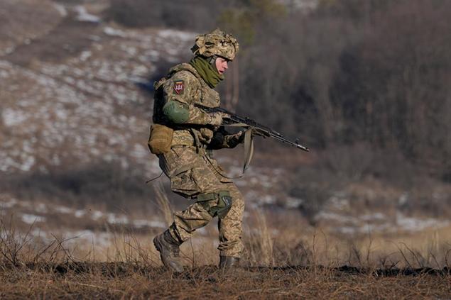 A Ukrainian serviceman runs during an exercise in the Joint Forces Operation, in the Donetsk region, eastern Ukraine, Tuesday, Feb. 15, 2022. While the U.S. warns that Russia could invade Ukraine any day, the drumbeat of war is all but unheard in Moscow, where pundits and ordinary people alike don't expect President Vladimir Putin to launch an attack on its ex-Soviet neighbor. (AP Photo/Vadim Ghirda)