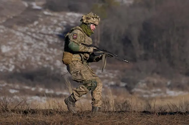 A Ukrainian serviceman runs during an exercise in the Joint Forces Operation, in the Donetsk region, eastern Ukraine, Tuesday, Feb. 15, 2022. While the U.S. warns that Russia could invade Ukraine any day, the drumbeat of war is all but unheard in Moscow, where pundits and ordinary people alike don't expect President Vladimir Putin to launch an attack on its ex-Soviet neighbor. (AP Photo/Vadim Ghirda)