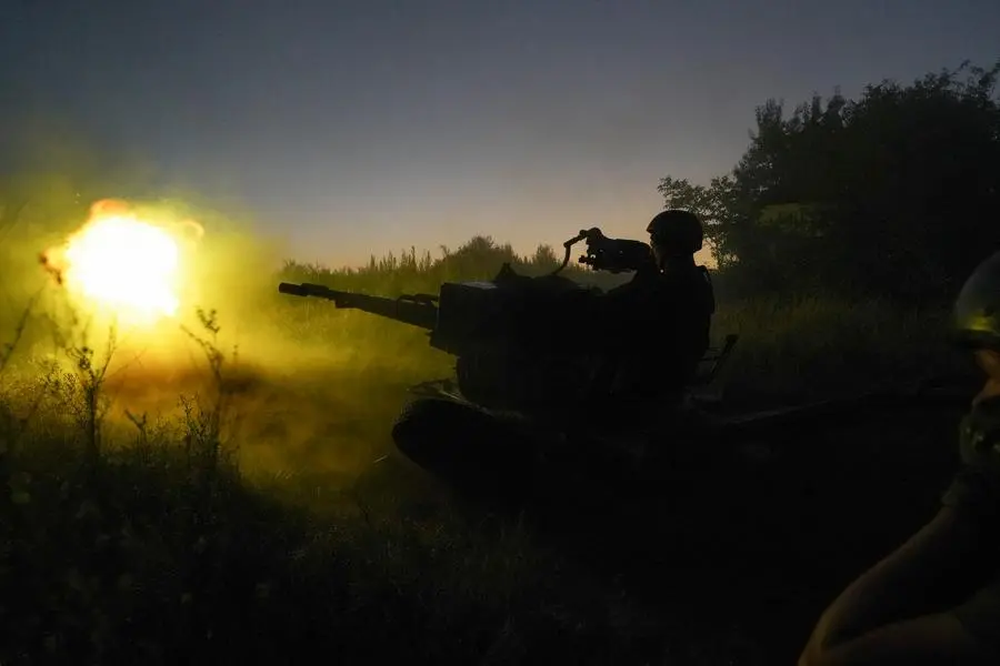Ukrainian servicemen fire to Russian positions from anti-aircraft gun in Kharkiv region, Ukraine, early Wednesday, Aug. 24, 2022. (AP Photo/Andrii Marienko)