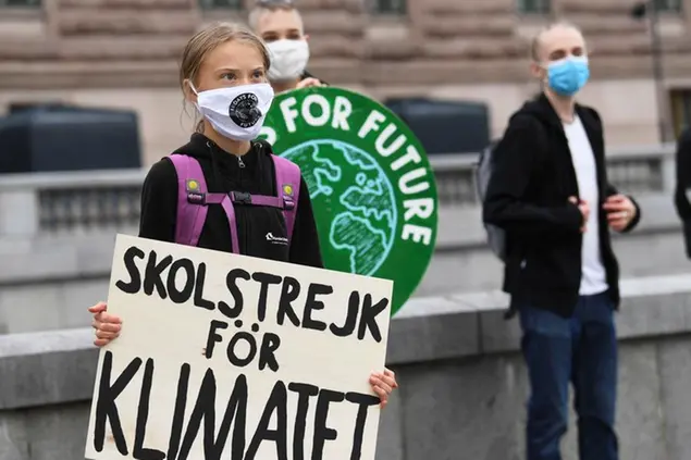 Swedish climate activist Greta Thunberg holds a poster reading \\\"School strike for Climate\\\" as she protests in front of the Swedish Parliament Riksdagen, in Stockholm, Friday Sept. 4, 2020. The 17-year-old Swedish climate activist Greta Thunberg said Monday she is heading back to school after a year off, but has resumed her weekly climate protests outside Sweden's parliament. (Fredrik Sandberg / TT via AP)
