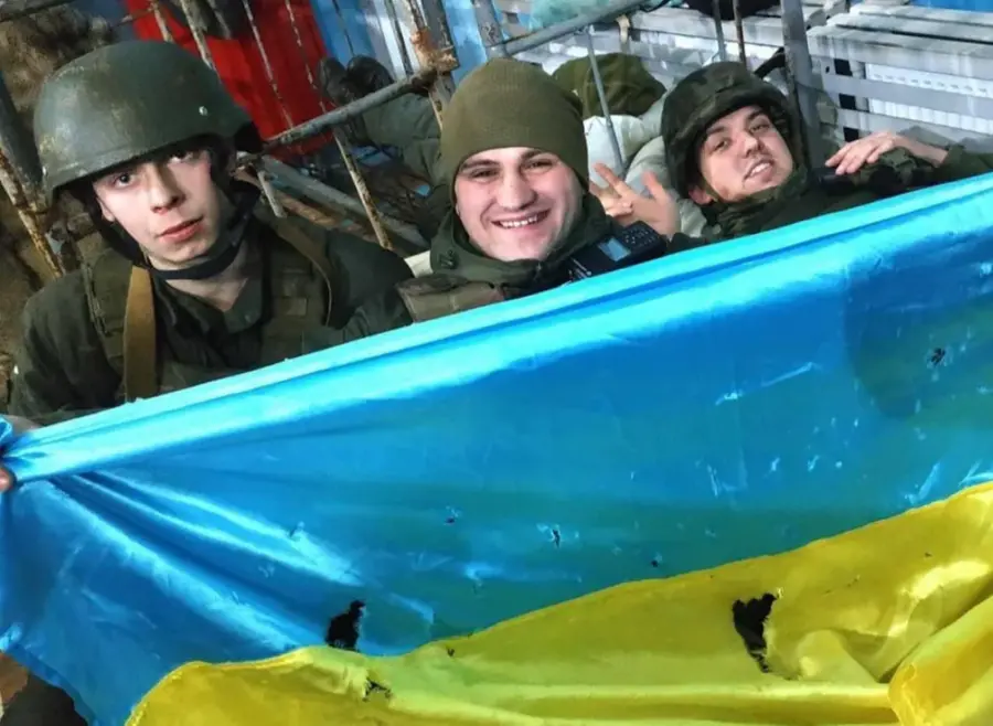 Soldati ucraini con una bandiera ucraina nei pressi dell'aeroporto Antonov