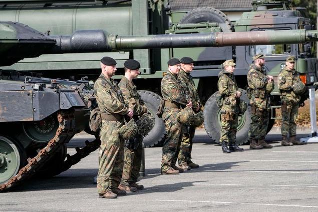 German soldiers stand at a Leopard tank during a visit of Governor Hendrick Wuest at the army base Field Marshal Rommel Barracks in Augustdorf, Germany, Wednesday, March 30, 2022. After Russia's attack on Ukraine, Germany decided to increase its defense budget and give the Bundeswehr an extra 100 billion Euro. (AP Photo/Martin Meissner)