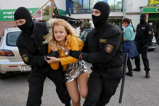 Police officers detain a woman during an opposition rally to protest the official presidential election results in Minsk, Belarus, Saturday, Sept. 19, 2020. Daily protests calling for the authoritarian president\\\\'s resignation are now in their second month and opposition determination appears strong despite the detention of protest leaders. (AP Photo/TUT.by)