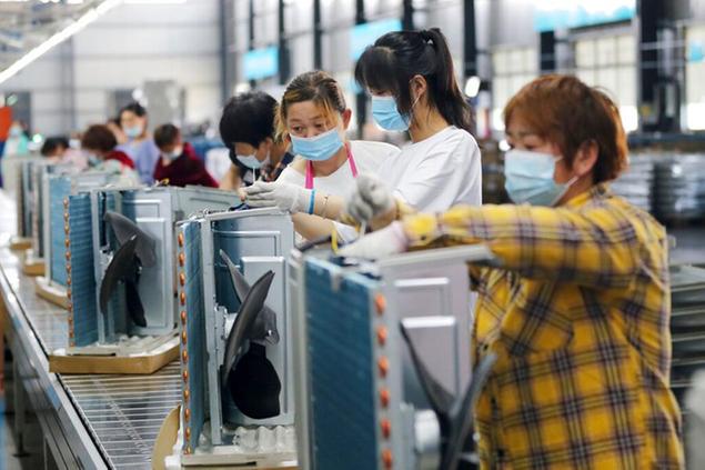Women work on the assembly line of air conditioners at a plant in Suixi county in central China's Anhui province Tuesday, May 18, 2021. (FeatureChina via AP Images)