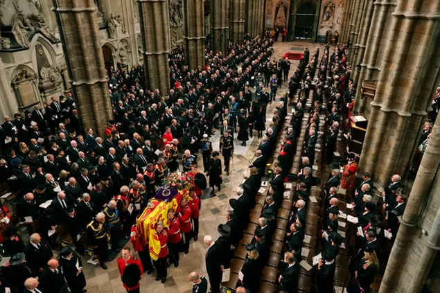 King Charles III, Camilla, Queen Consort and other members of the Royal family follow the coffin of Queen Elizabeth II as it is carried into Westminster Abbey ahead of her State Funeral, in London, Monday Sept. 19, 2022. The Queen, who died aged 96 on Sept. 8, will be buried at Windsor alongside her late husband, Prince Philip, who died last year. (Jack Hill/Pool Photo via AP)