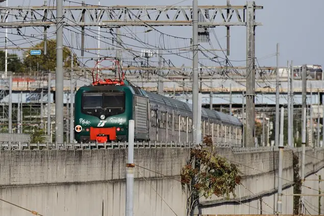 A Trenord train runs on the rails in Milan, Italy, Wednesday, Sept. 30, 2020. (AP Photo/Luca Bruno)