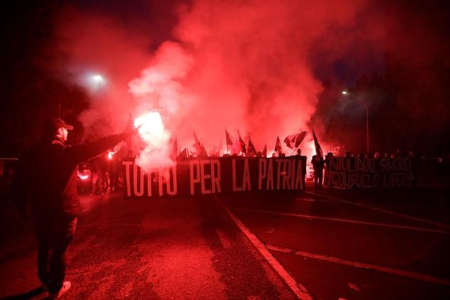 Italian far-right wing party activists hold flares and a banner reading \\\"All for the fatherland\\\" during a march against the government-proposed reform of the citizenship procedures for the descendants of immigrants living in Italy, in Rome, Saturday, Nov. 4, 2017. (AP Photo/Alessandra Tarantino)