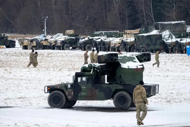 US soldiers walk at a local airport in Arlamow, southeastern Poland, near the border with Ukraine\\u00A0(AP Photo/Czarek Sokolowski)