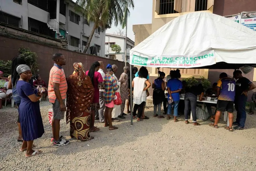 People queue to collect their elections permanent voters card ahead of Feb. 2023 Presidential elections in Lagos, Nigeria, Wednesday, Jan. 11, 2023. (AP Photo/Sunday Alamba)