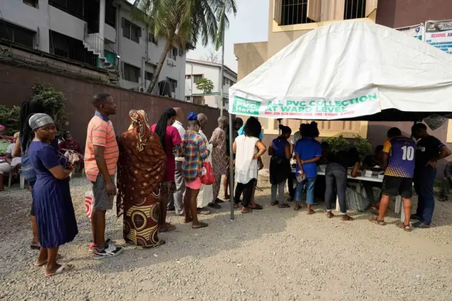 People queue to collect their elections permanent voters card ahead of Feb. 2023 Presidential elections in Lagos, Nigeria, Wednesday, Jan. 11, 2023. (AP Photo/Sunday Alamba)