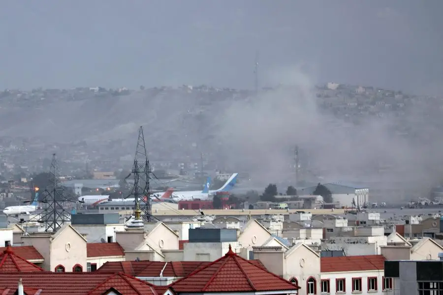 Smoke rises from explosion outside the airport in Kabul, Afghanistan, Thursday, Aug. 26, 2021. The explosion went off outside Kabul’s airport, where thousands of people have flocked as they try to flee the Taliban takeover of Afghanistan. Officials offered no casualty count, but a witness said several people appeared to have been killed or wounded Thursday. (AP Photo/Wali Sabawoon)