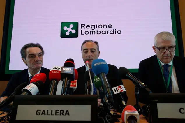 Giulio Gallera, Health Counselor for the Lombardy Region, center, is flanked by Attilio Fontana, left, president of Lombardy region, and by Luigi Caiazzo, a director general of Welfare for the Lombardy region, during a press conference in Milan, Italy, Friday, 21, 2020. In Italy, three more people, from two Lombardy towns, tested positive for the virus, the first cases of contagion among Italians who hadn’t been to China, authorities said. (AP Photo/Antonio Calanni)