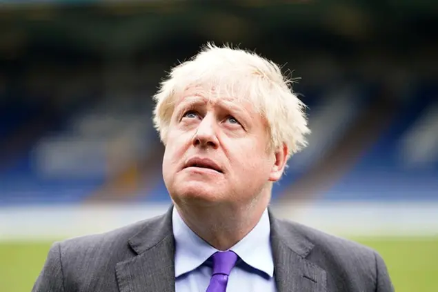 Britain's Prime Minister Boris Johnson looks on during a visit to Bury FC at their ground in Gigg Lane, Bury, Greater Manchester, England, Monday April 25, 2022. (Danny Lawson/Pool Photo via AP)