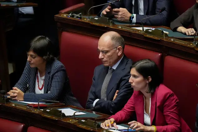 Democratic Party leader Enrico Letta, center, with colleagues Debora Serracchiani, left, and Emily Schlein, listens to Italian Premier Giorgia Meloni addressing the lower Chamber ahead of a confidence vote for her Cabinet, Tuesday, Oct. 25, 2022. Giorgia Meloni, whose party with neo-fascist roots finished first in recent elections, is Italy's first far-right premier since the end of World War II. She is also the first woman to serve as Italian premier. (AP Photo/Alessandra Tarantino)