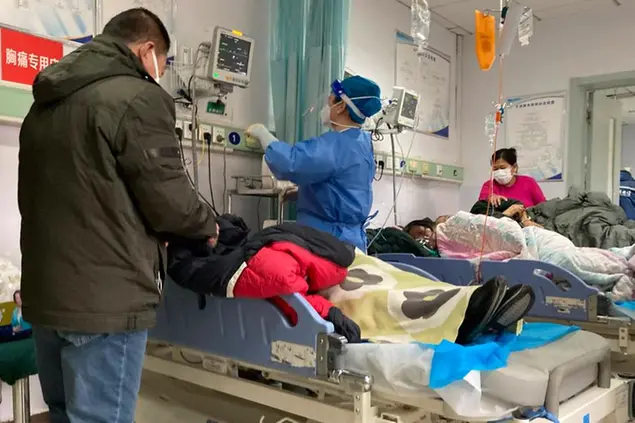 Patients recover at the Baoding No. 2 Central Hospital in Zhuozhou city in northern China's Hebei province on Wednesday, Dec. 21, 2022. China only counts deaths from pneumonia or respiratory failure in its official COVID-19 death toll, a Chinese health official said, in a narrow definition that limits the number of deaths reported, as an outbreak of the virus surges following the easing of pandemic-related restrictions. (AP Photo/Dake Kang)