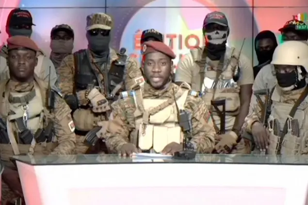In this image from video broadcast by RTB state television, coup spokesman Capt. Kiswendsida Farouk Azaria Sorgho reads a statement in a studio in Ougadougou, Burkina Faso, on Friday evening, Sept. 30, 2022. Members of Burkina Faso's army seized control of state television late Friday, declaring that the country's coup leader-turned-president, Lt. Col. Paul Henri Sandaogo Damiba, had been overthrown after only nine months in power. The statement announced that Capt. Ibrahim Traore is the new military leader of Burkina Faso, a volatile West African country that is battling a mounting Islamic insurgency. (RTB via AP)