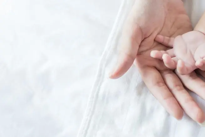 Asian parent hands holding newborn baby fingers, Close up mother's hand holding their new born baby. Love family healthcare and medical body part father's day concept panoramic banner