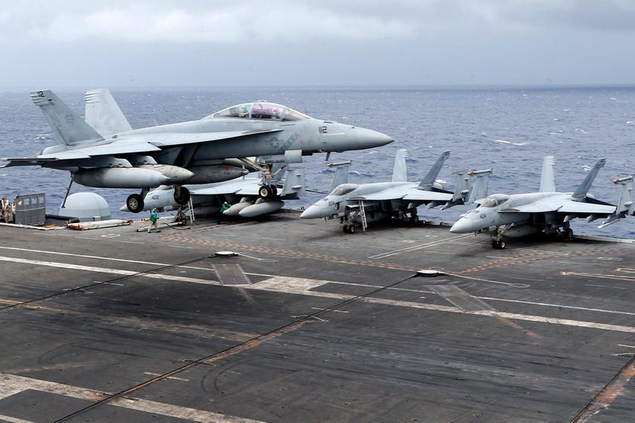 A U.S. fighter jet lands on the U.S. aircraft carrier USS Ronald Reagan following their patrol at the international waters off South China Sea Tuesday, Aug. 6, 2019. The USS Ronald Reagan is cruising in international waters in the South China Sea amid tensions in the disputed islands, shoals and reefs between China and other claimant-countries as Philippines, Vietnam and Malaysia. (AP Photo/Bullit Marquez)