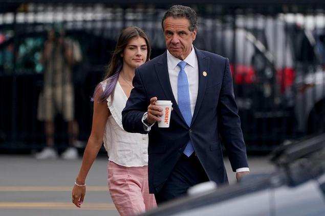 New York Gov. Andrew Cuomo, right, prepares to board a helicopter with his daughter Michaela Cuomo after announcing his resignation, Tuesday, Aug. 10, 2021, in New York. Cuomo says he will resign over a barrage of sexual harassment allegations. The three-term Democratic governor's decision, which will take effect in two weeks, was announced Tuesday as momentum built in the Legislature to remove him by impeachment. (AP Photo/Seth Wenig)